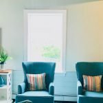 teal chairs and bright pillows
